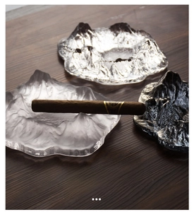 Detail of frosted, clear and smoky glass cigar ashtrays with Japanese glacier design