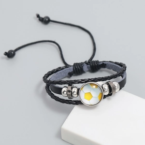 Detail of multi-layer soccer themed leather bracelet with adjustable cords and metal beads
