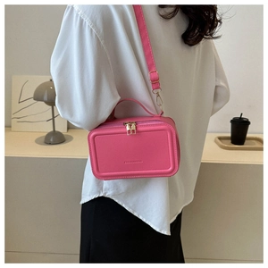 Pink PU leather suitcase style crossbody bag with adjustable strap and top handle