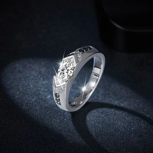 Marquise cut moissanite ring in silver with black side stones on blue background
