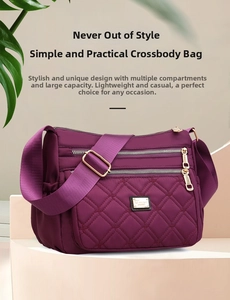 Detail view of purple quilted nylon dumpling bag with multi-zipper layers and gold hardware