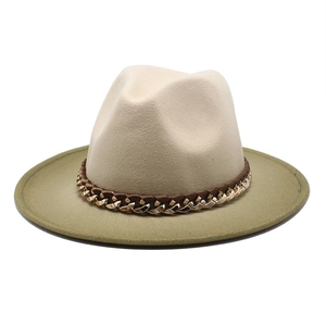 Detail of fedora hat with beige crown, olive green brim, and gold chain ribbon trim