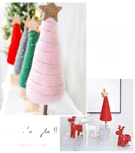 Detailed view of pink wool felt Christmas tree with golden stars and wooden base