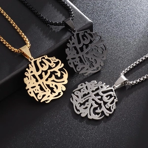 Three stainless steel tree of life necklaces in gold, silver and black finish on dark background