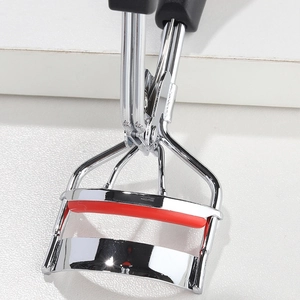 Detailed close-up of a stainless steel eyelash curler with a durable red silicone pad