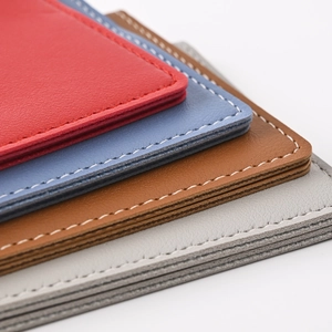 Close-up of stitched PU leather edges in red, blue, brown, and grey colors