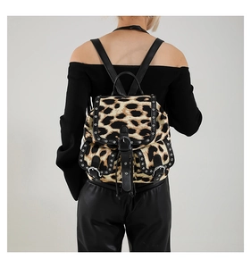 Detailed back view of a punk leopard print backpack with silver rivets and buckled pockets