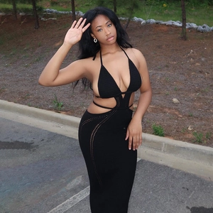 Detail view of black knit halter dress featuring cut-out waist and open back design