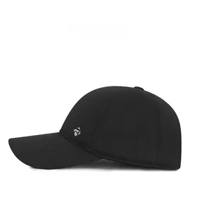Detail view of the silver diamond metal logo on the side of a black wool winter baseball cap
