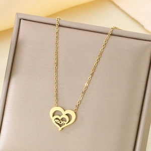 Détail du pendentif cœur en or 18K avec gravure MOM sur doublure en soie dans un coffret