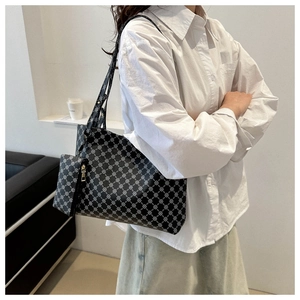 Modern geometric tote bag styled with a white shirt and casual skirt for everyday wear