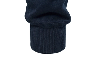 Close-up of navy blue knitted cardigan showing rib-knit cuffs and fine texture