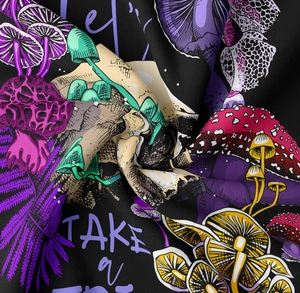 Detail of mushroom tapestry with Let's TAKE a TRIP text on soft black twill fabric