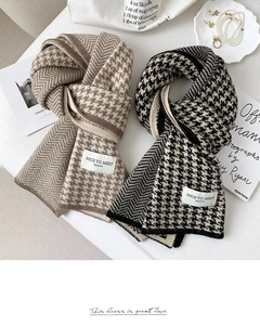 Detailed flat lay of knitted houndstooth scarf with coffee and black splicing texture