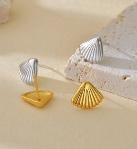 Macro detail of S925 sterling silver shell earrings in gold and silver finishes