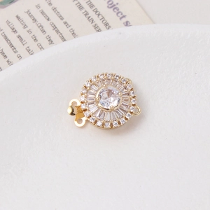 Detailed view of 14K gold plated flower clasp with shimmering cubic zirconia and pearls