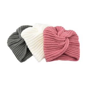 Detail of twisted knit turban hats in dark grey, ivory white and pink cashmere feel fabric
