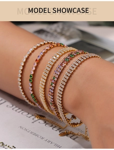 Close-up of gold-plated tennis bracelets with colorful zircons on a model wrist