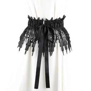 Detailed view of black lace corset belt with intricate feather patterns and satin ribbon bow