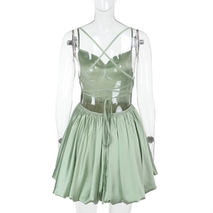 Detailed view of light green backless strap dress with cross-tie design and flared hemline