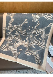 Detail shot of the zebra pattern texture and soft fringes on a bohemian square scarf
