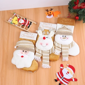 Three Christmas stockings with 3D Santa, Reindeer and Snowman on wood background