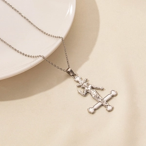Macro shot of silver stainless steel upside-down cross and Baphomet pendant necklace
