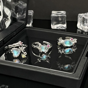 Silver adjustable rings set with colorful heart moonstone on mirror background