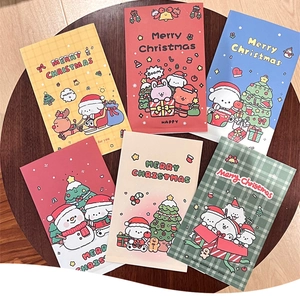 Detail of colorful Christmas themed paper gift bags with cute cartoon holiday illustrations
