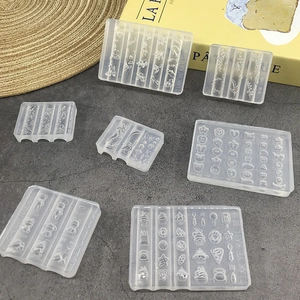 DIY cartoon silicone nail art molds with flower and mermaid patterns on grey background