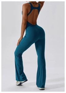 Detail of teal blue backless flared yoga jumpsuit with a racerback and fitted silhouette