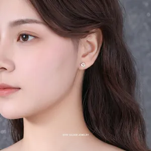 Elegant S999 sterling silver rose flower stud earring worn by a model in a side view