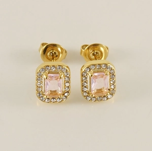 Macro view of 18K gold earrings with rectangular pink zircon and white pave stones
