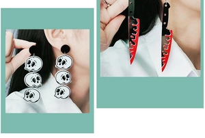 Detail shot of acrylic blood knife and triple skull earrings for Halloween jewelry