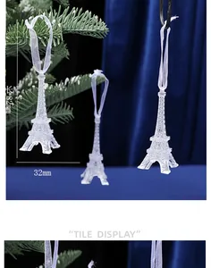 Detailed view of an 82mm Eiffel Tower acrylic Christmas ornament with white ribbon