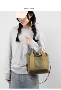 Detailed view of heavy canvas tote bag in army green worn by model with adjustable strap