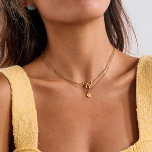 Gold double-layered stainless steel necklace featuring bow and heart pendants for women