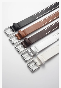 Detail view of multicolored studded PU leather belts with silver buckles and punk rivets