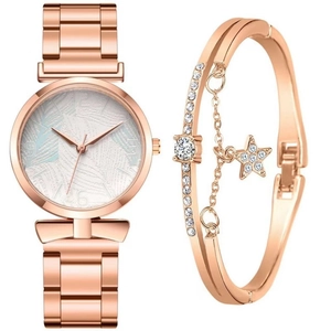 Detail of rose gold quartz watch with palm leaf dial and matching star charm bracelet