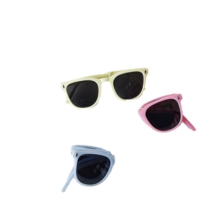 Foldable kids sunglasses in yellow pink and blue colors on white background