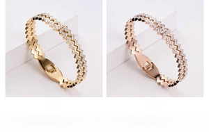Detail of gold and rose gold bangles with zigzag rhinestone inlay and spring clasp