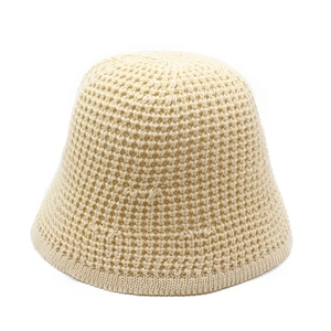 Close-up of beige knitted sun hat showing breathable hollow-out crochet mesh texture