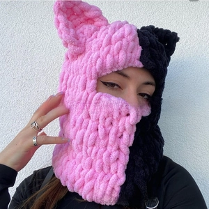 Detail of pink and black knit cat ear balaclava showing thick chenille texture