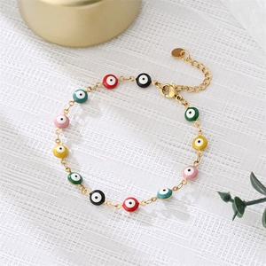 Close-up of gold chain bracelet with colorful evil eye charms and adjustable lobster clasp