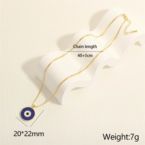Macro view of 18K gold-plated snake chain necklace with blue evil eye enamel pendant