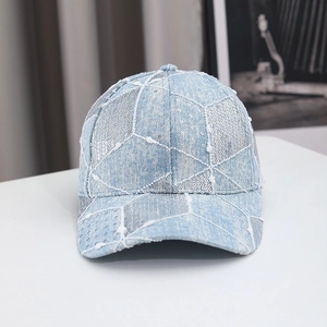 Denim blue baseball cap with silver sequins and a washed finish on a white background