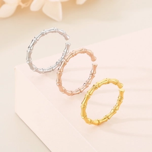 Three minimalist bamboo-style open rings in silver, rose gold, and gold plated stainless steel