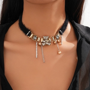 Detail of plush choker with bear pendant, faux pearls, and dangling gold tassel chains