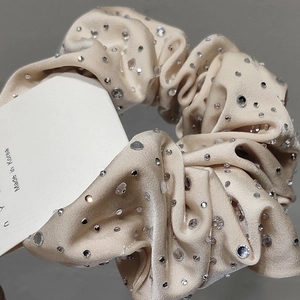 Elegant champagne satin scrunchie with sparkling rhinestones in a stylish French design