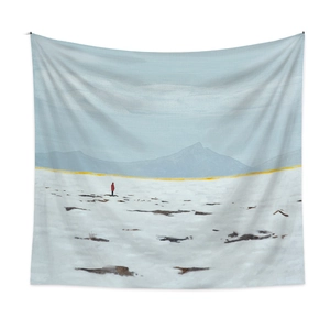 Detail of bohemian tapestry featuring minimalist snow field landscape art with red figure